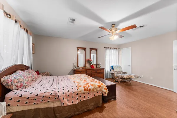 a bedroom with a bed a window and a chandelier