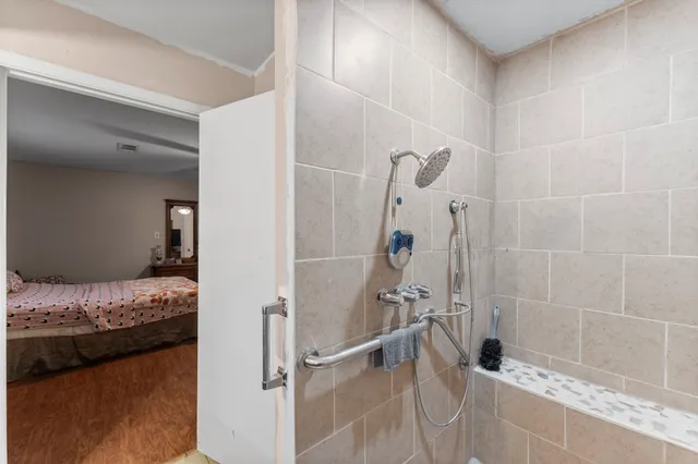 a bathroom with a granite countertop shower and a sink