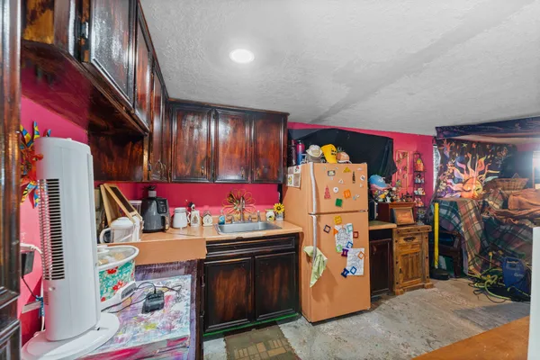 a utility room with stainless steel appliances and living room