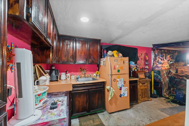 a utility room with stainless steel appliances and living room