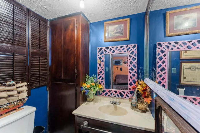 a bathroom with a sink vanity and a mirror