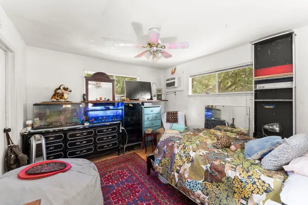 a bedroom with a bed and a flat screen tv