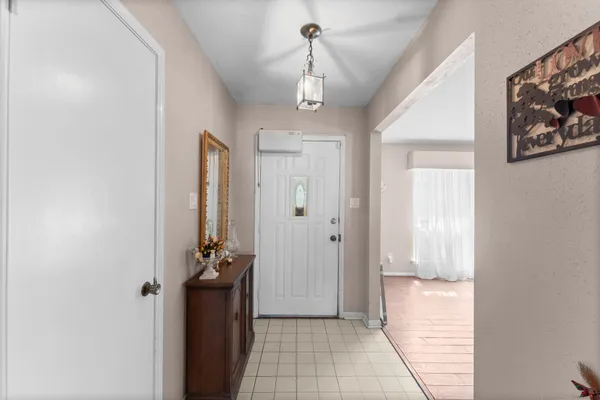 a view of a hallway view with wooden floor and staircase
