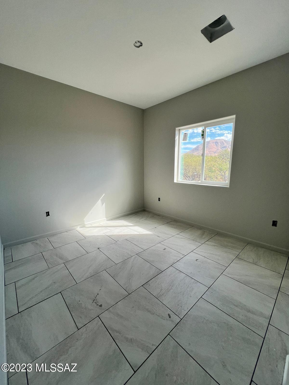 1830 Alpine Court Rio Rico, AZ 85648 - Photo 5 of 9 a view of an empty room with a window