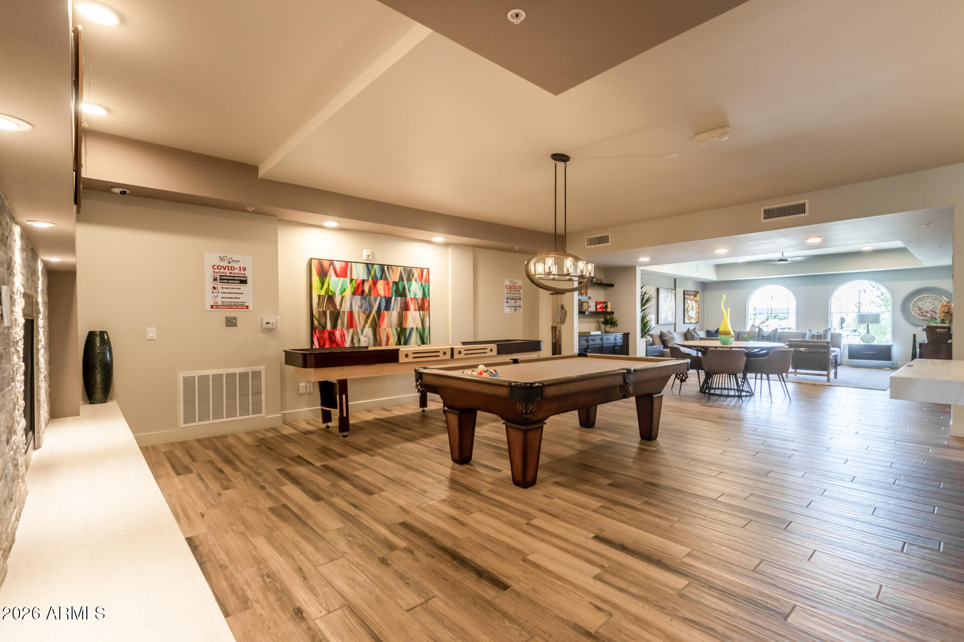 2511 West Queen Creek Road, Unit 239 Chandler, AZ 85248 - Photo 30 of 34 a living room with furniture a table and wooden floor