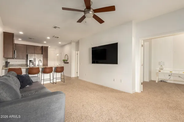 a living room with furniture and kitchen view