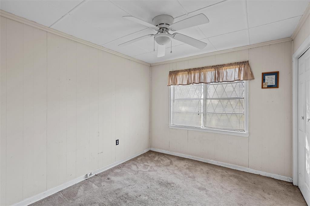 1227 McLennan Crossing Road Woodway, TX 76712 - Photo 14 of 30 an empty room with chandelier fan and windows
