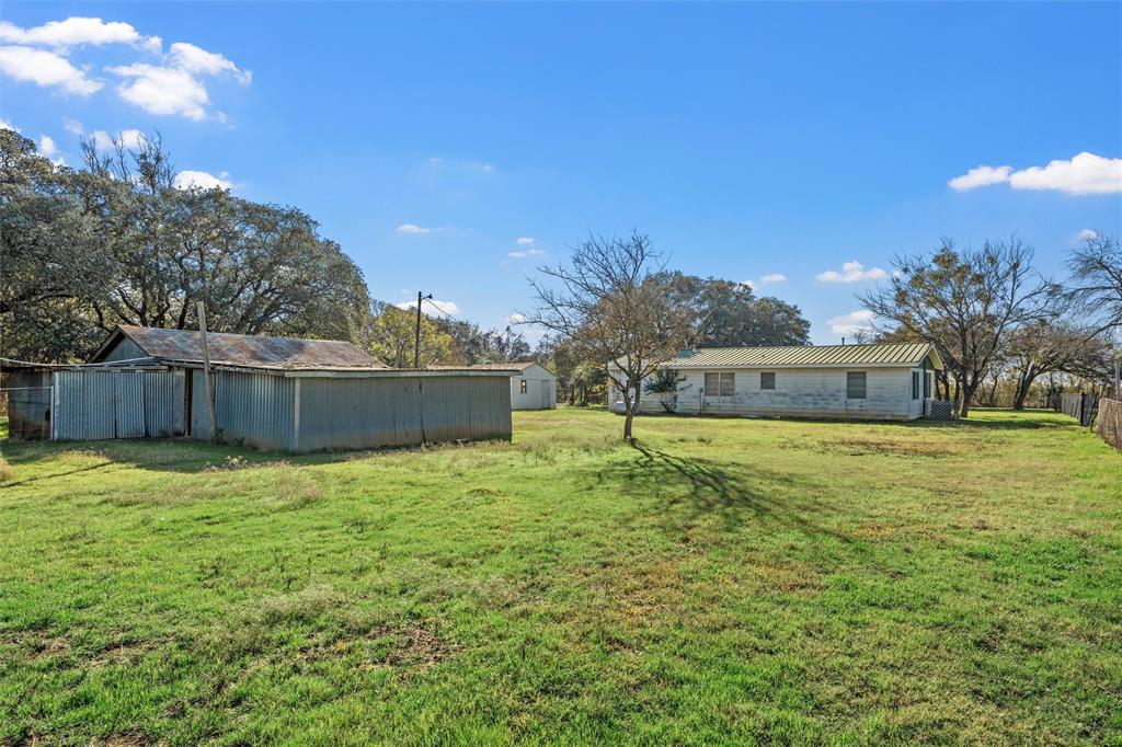 1227 McLennan Crossing Road Woodway, TX 76712 - Photo 20 of 30 a backyard of a house with lots of green space