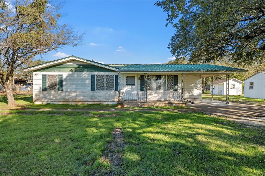 1227 McLennan Crossing Road Woodway, TX 76712 - Photo 2 of 30 a front view of a house with a yard table and chairs