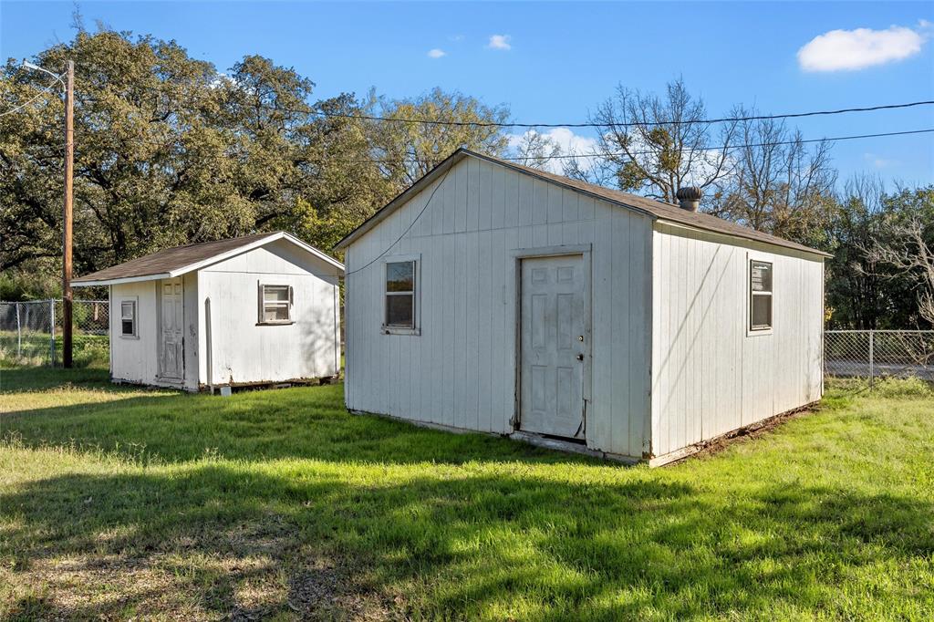 1227 McLennan Crossing Road Woodway, TX 76712 - Photo 21 of 30 a view of a backyard with plants and large trees with wooden fence