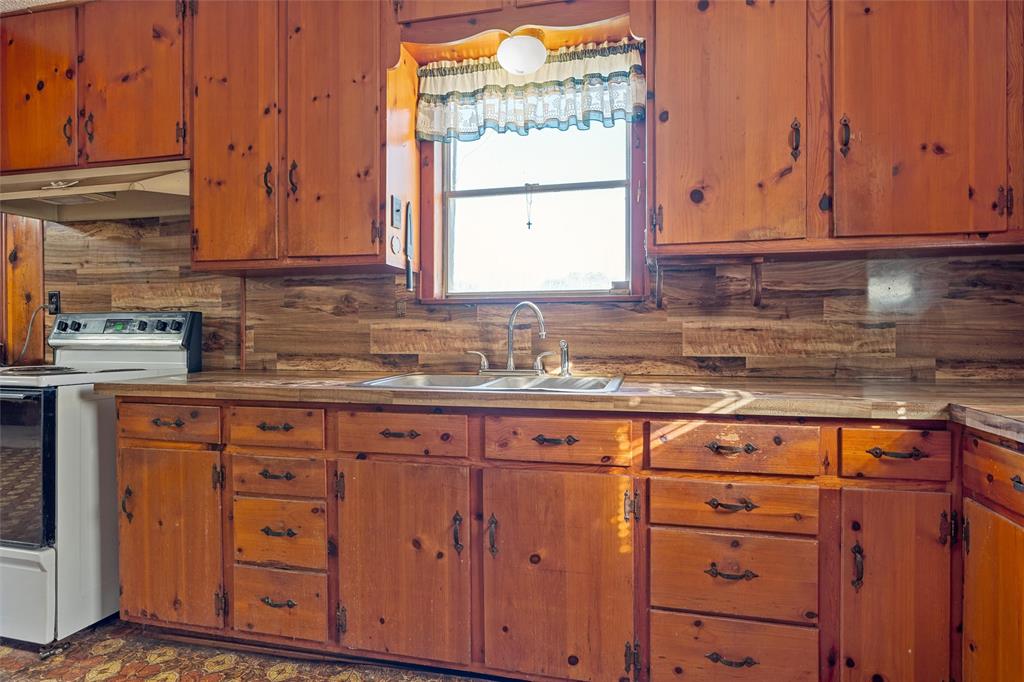 1227 McLennan Crossing Road Woodway, TX 76712 - Photo 9 of 30 a kitchen with stainless steel appliances granite countertop cabinets and a sink