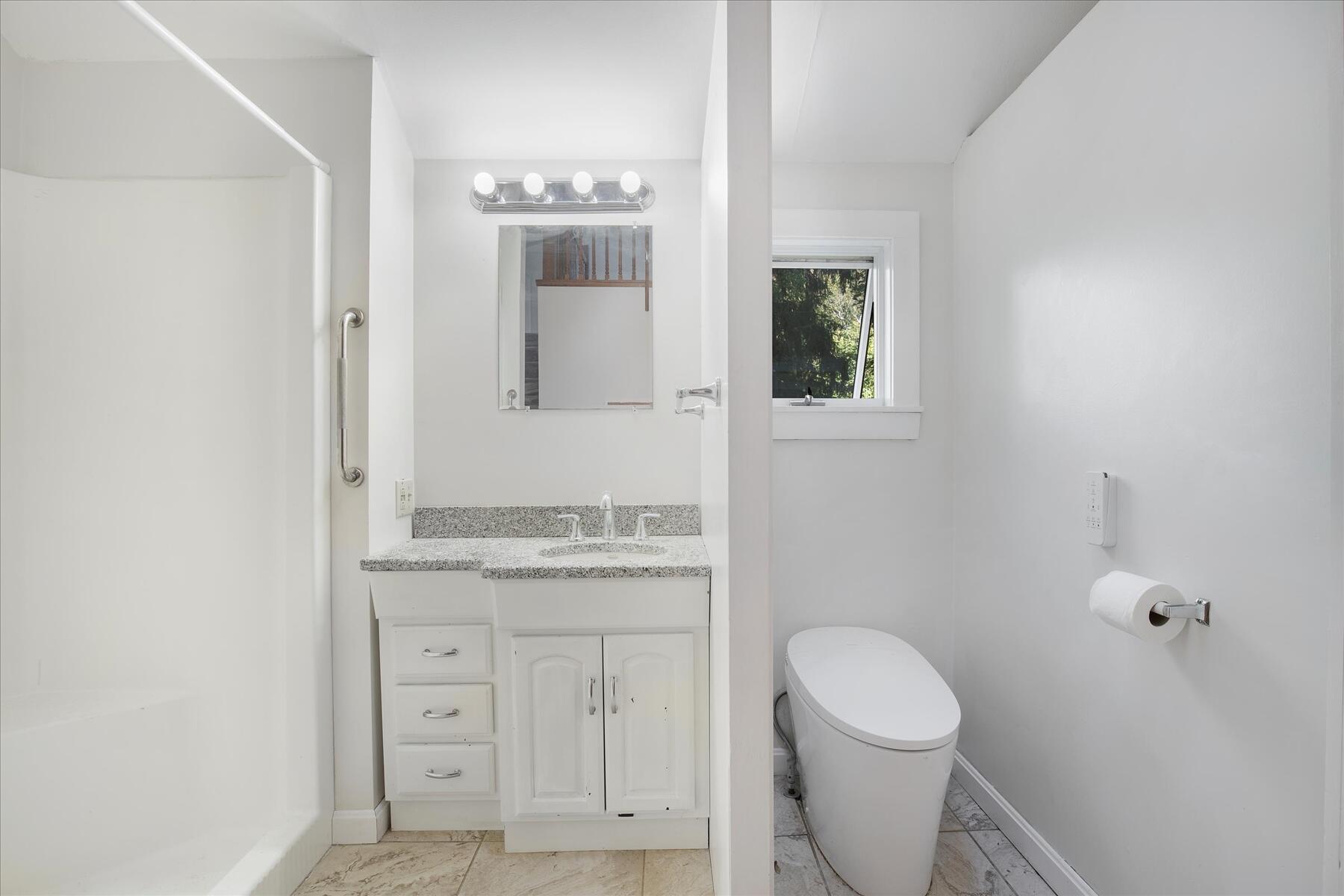 254 Barlows Landing Road Pocasset, MA 02559 - Photo 11 of 27 a bathroom with a granite countertop toilet sink and mirror