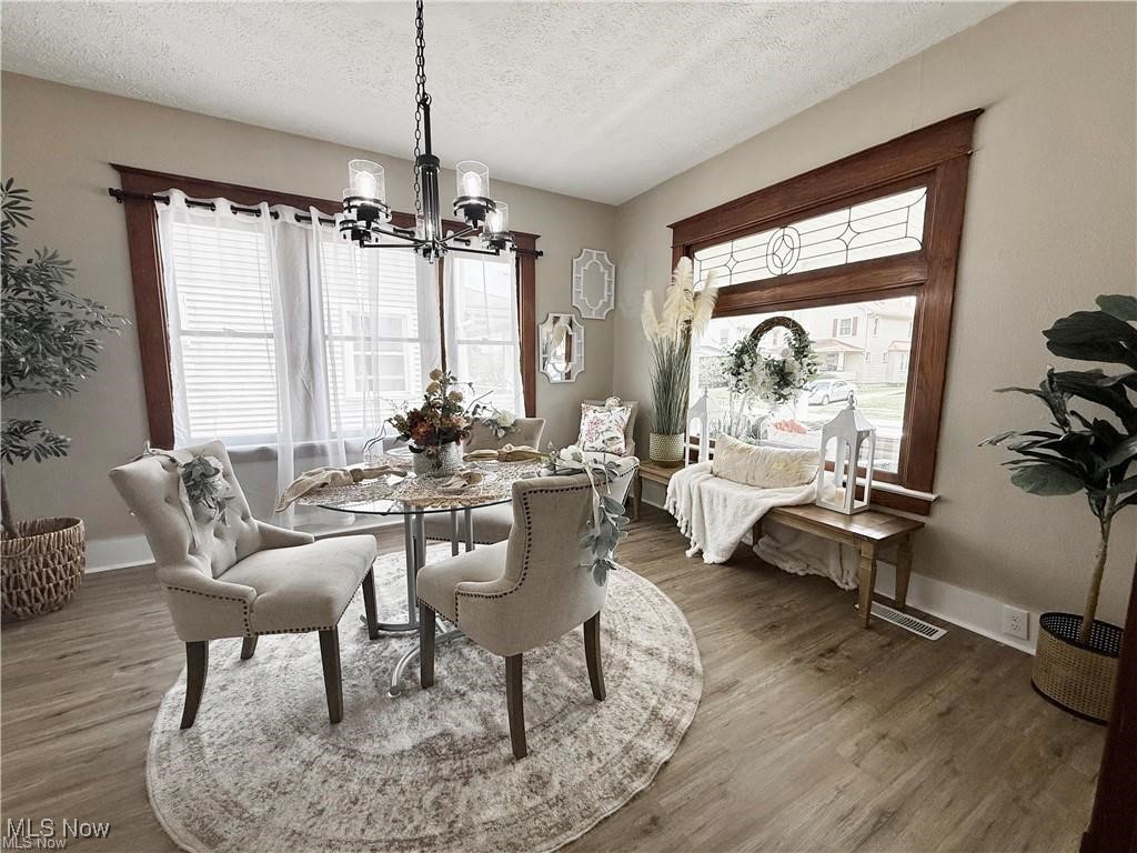 281 Sexton Street Struthers, OH 44471 - Photo 7 of 28 Dining room with a chandelier, a textured ceiling, and wood finished floors