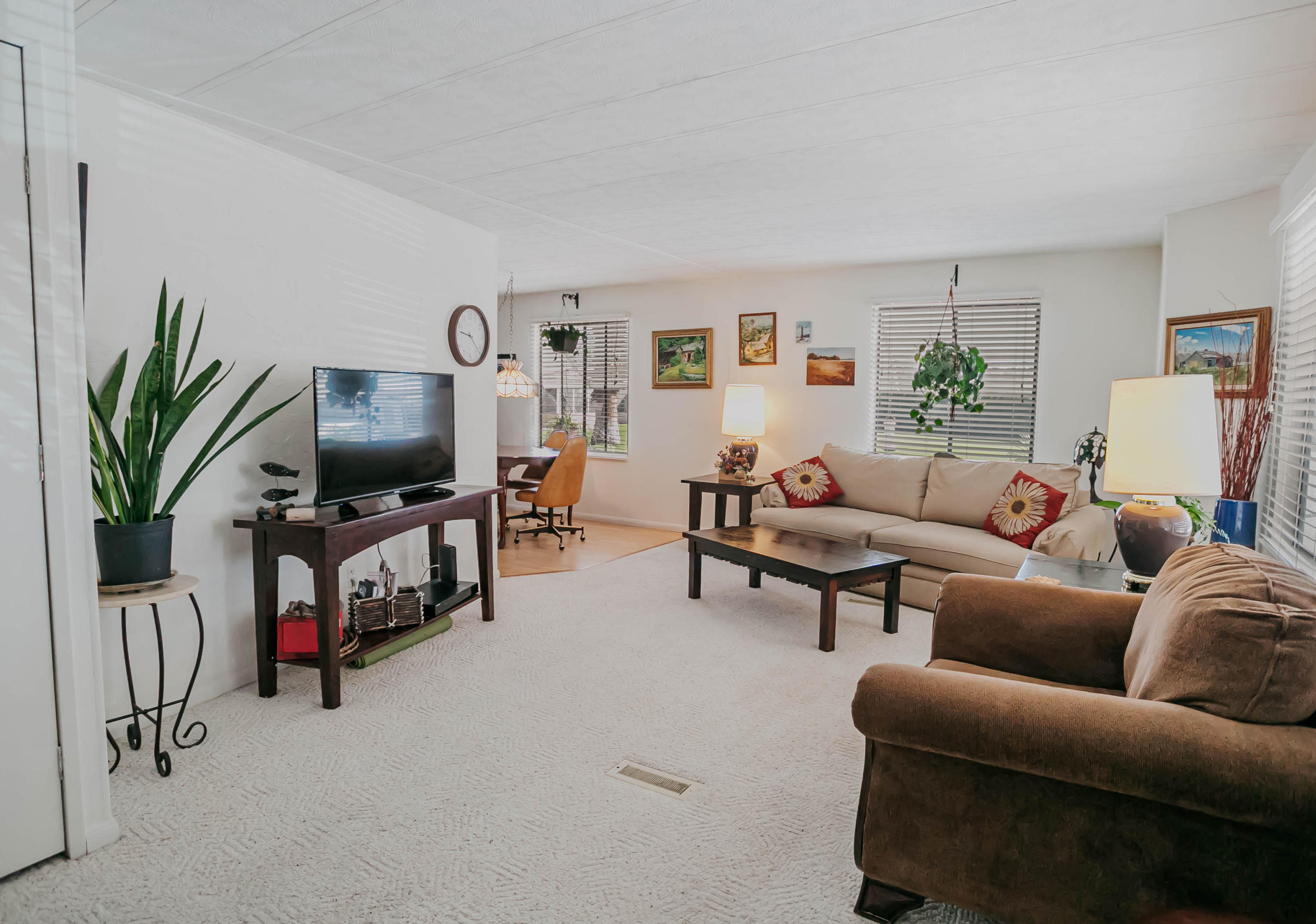 51555 Monroe Street, Unit 26 Indio, CA 92201 - Photo 15 of 54 a living room with furniture a flat screen tv and a potted plant
