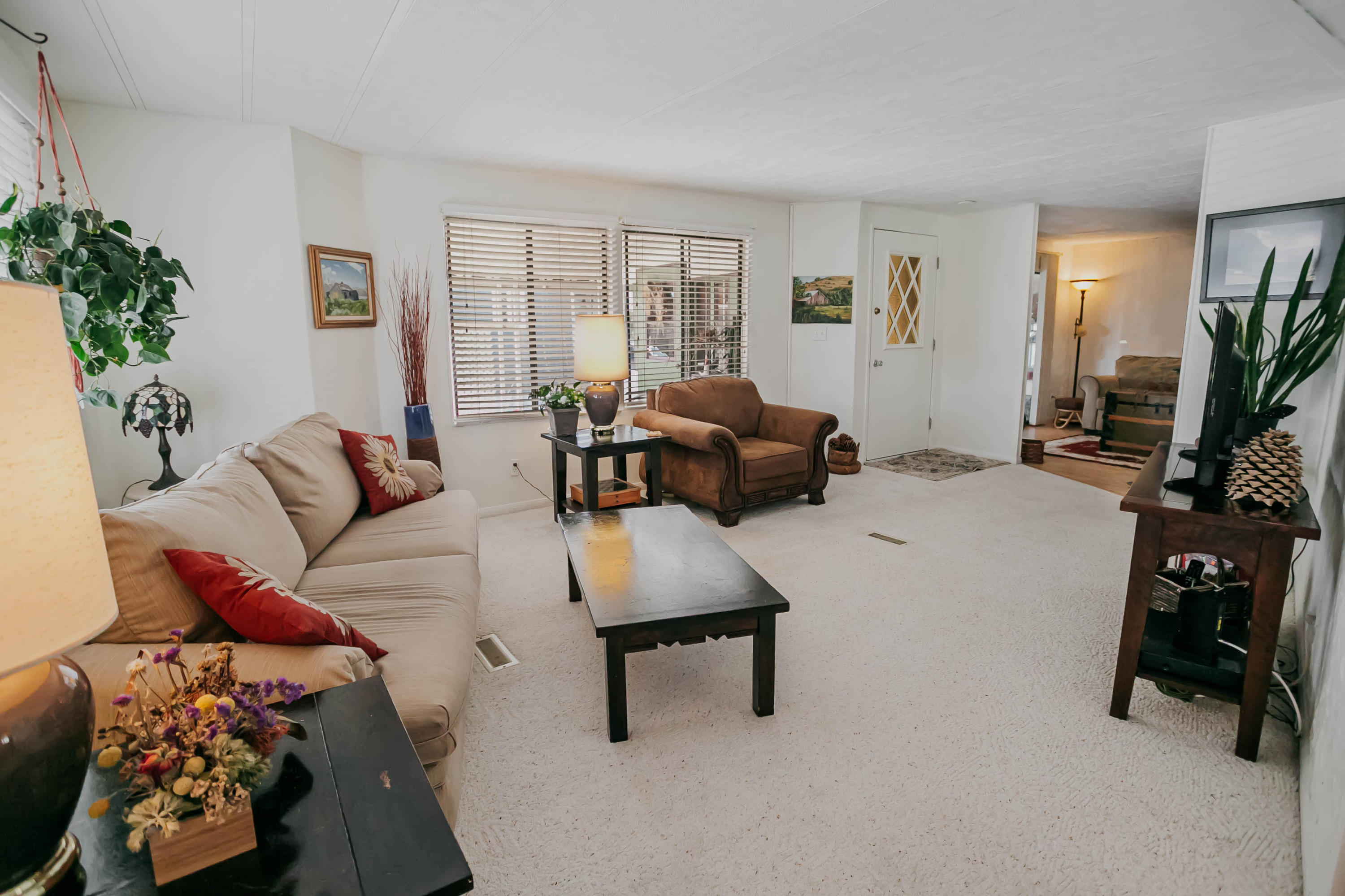 51555 Monroe Street, Unit 26 Indio, CA 92201 - Photo 17 of 54 a living room with furniture and a flat screen tv