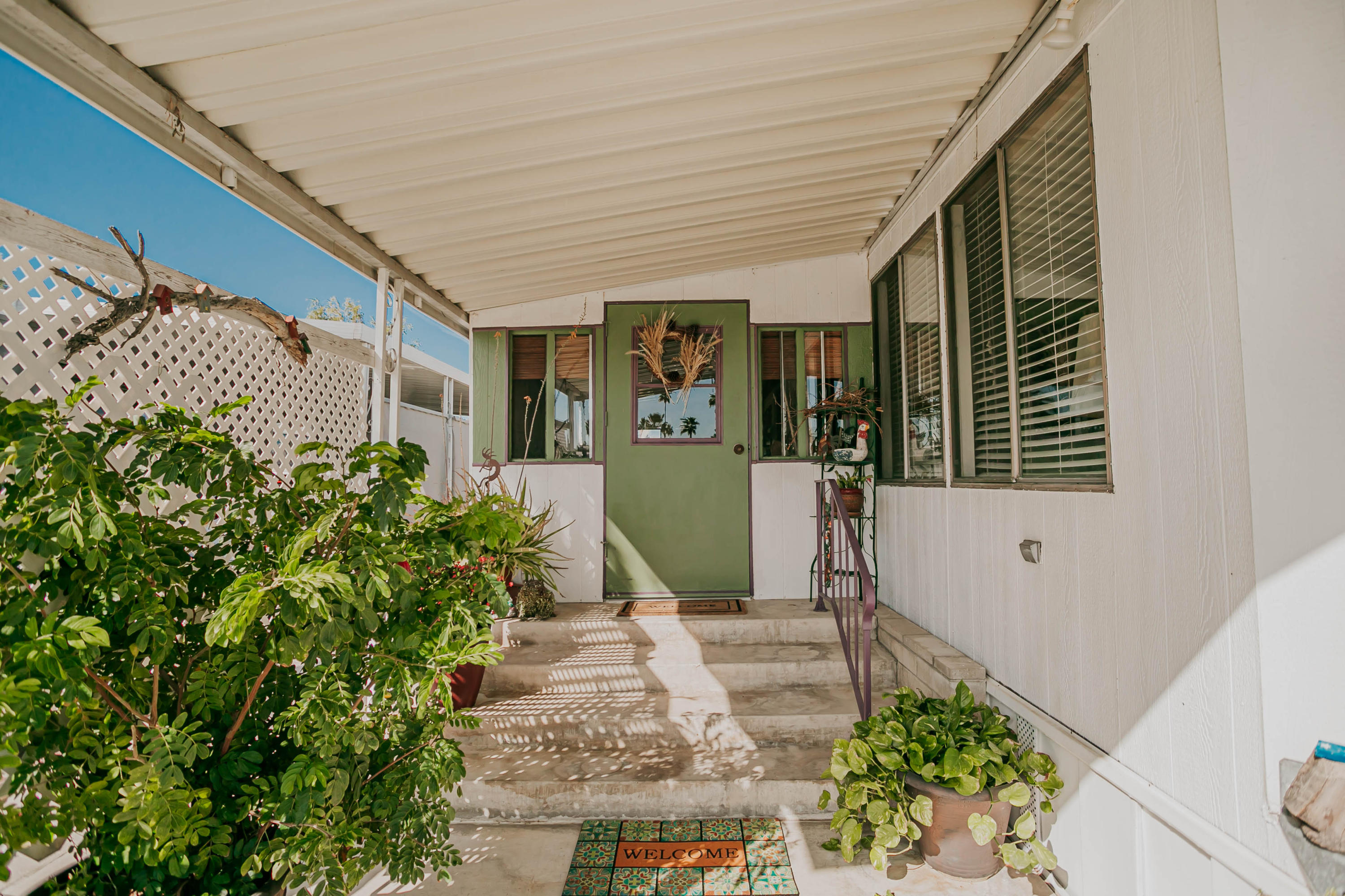 51555 Monroe Street, Unit 26 Indio, CA 92201 - Photo 3 of 54 a view of a house with potted plants