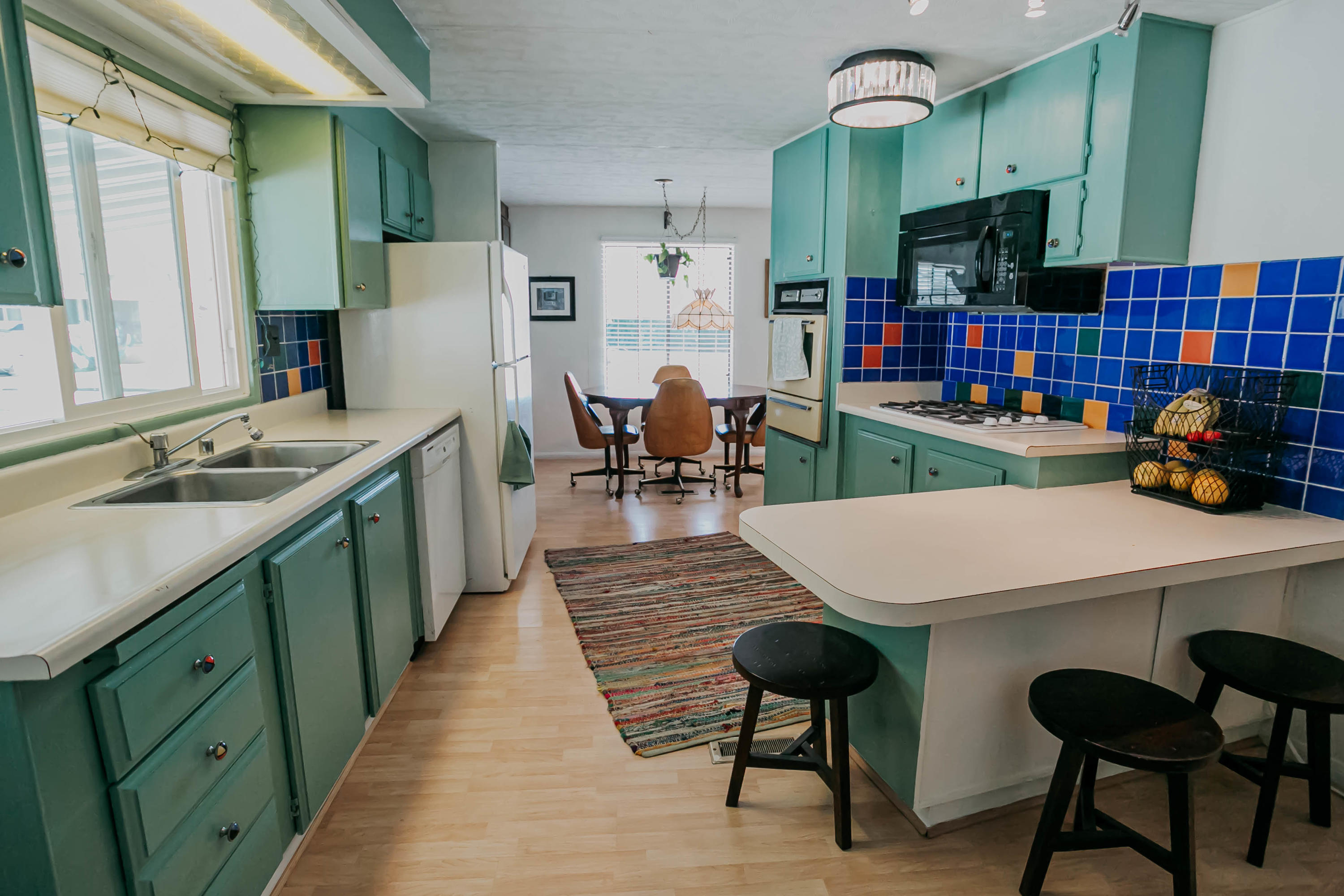 51555 Monroe Street, Unit 26 Indio, CA 92201 - Photo 21 of 54 a kitchen with a sink a table and chairs