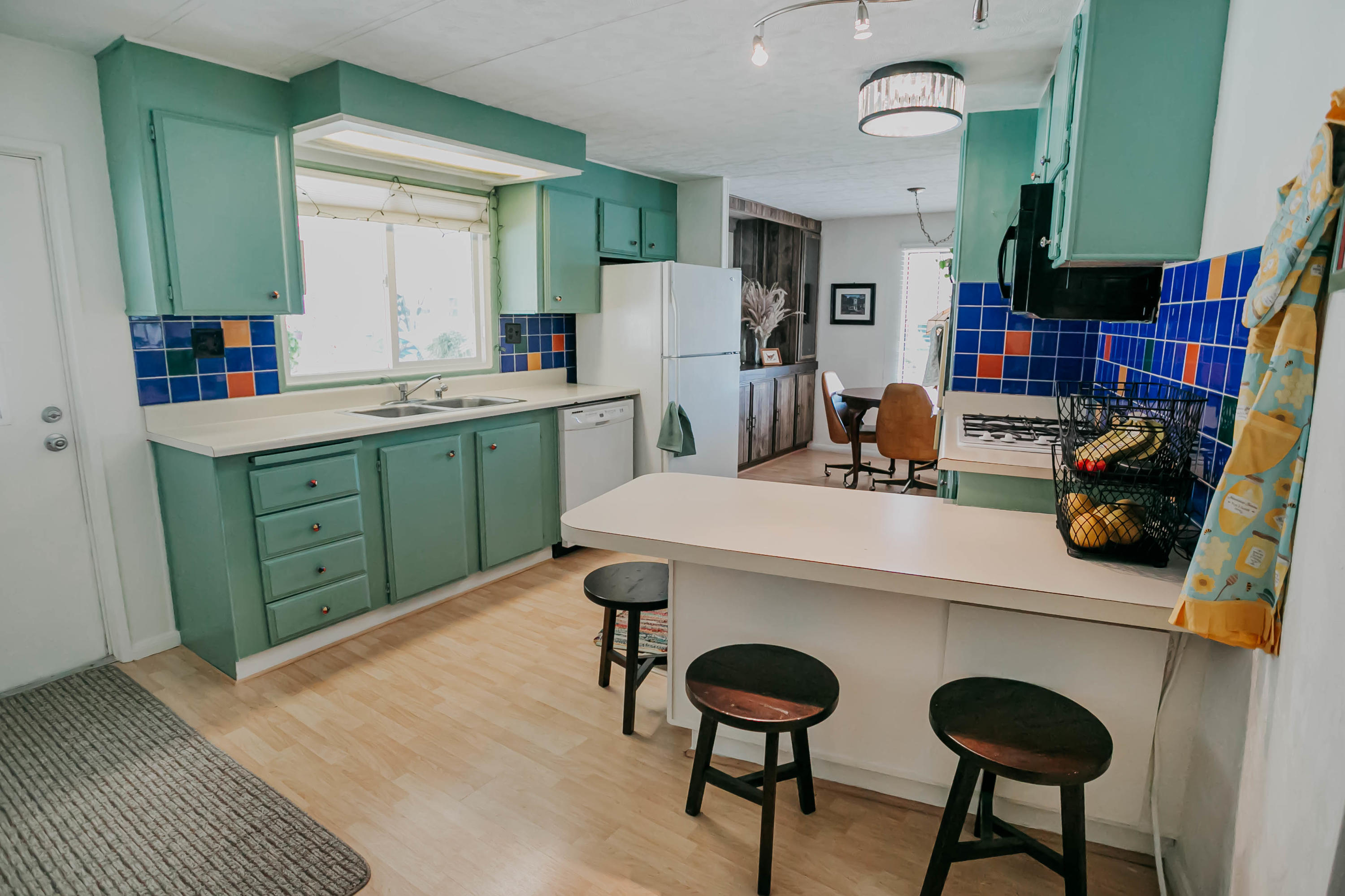 51555 Monroe Street, Unit 26 Indio, CA 92201 - Photo 22 of 54 a kitchen with a sink cabinets and wooden floor
