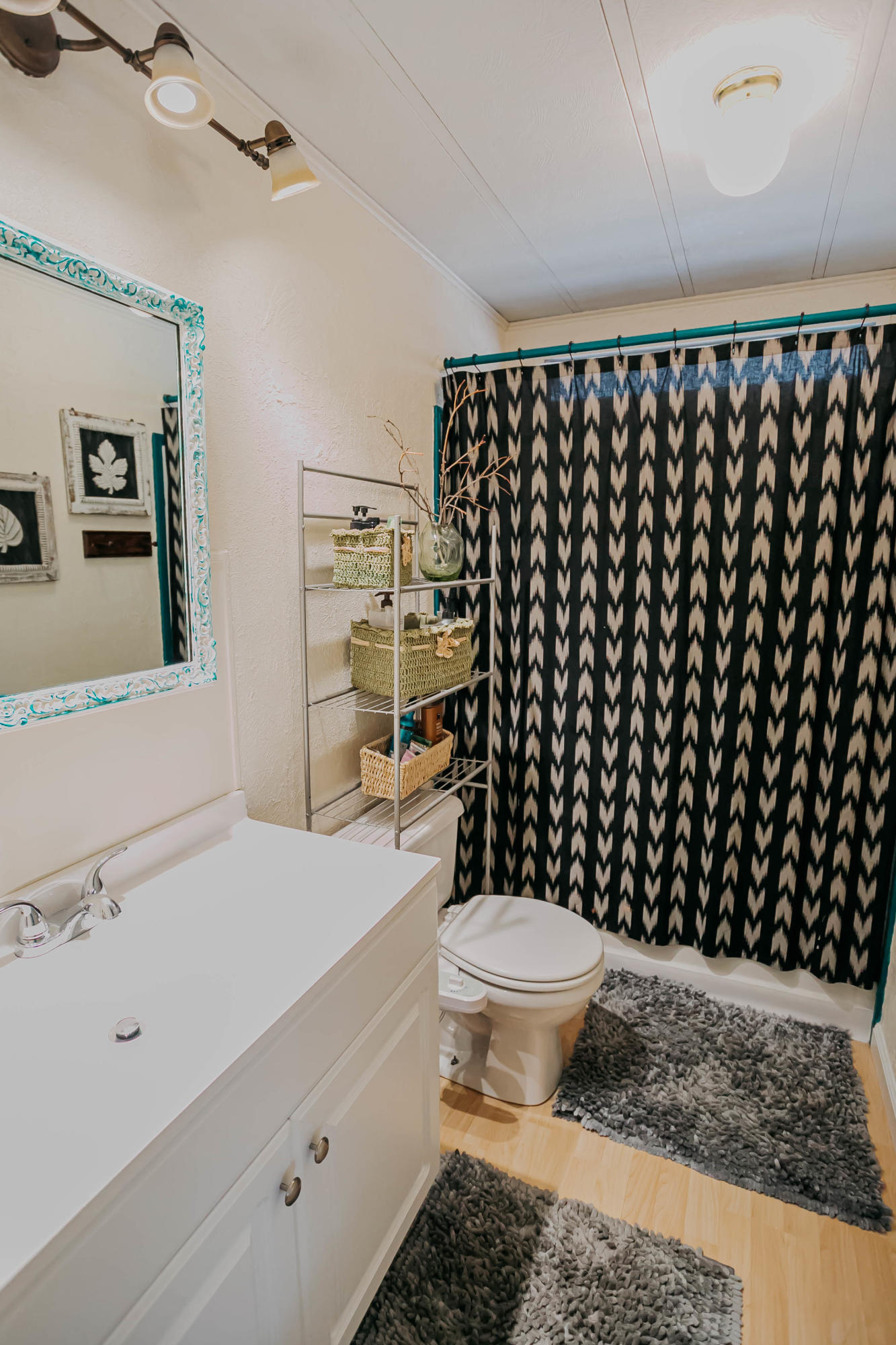 51555 Monroe Street, Unit 26 Indio, CA 92201 - Photo 27 of 54 a bathroom with a sink a toilet and a shower curtain