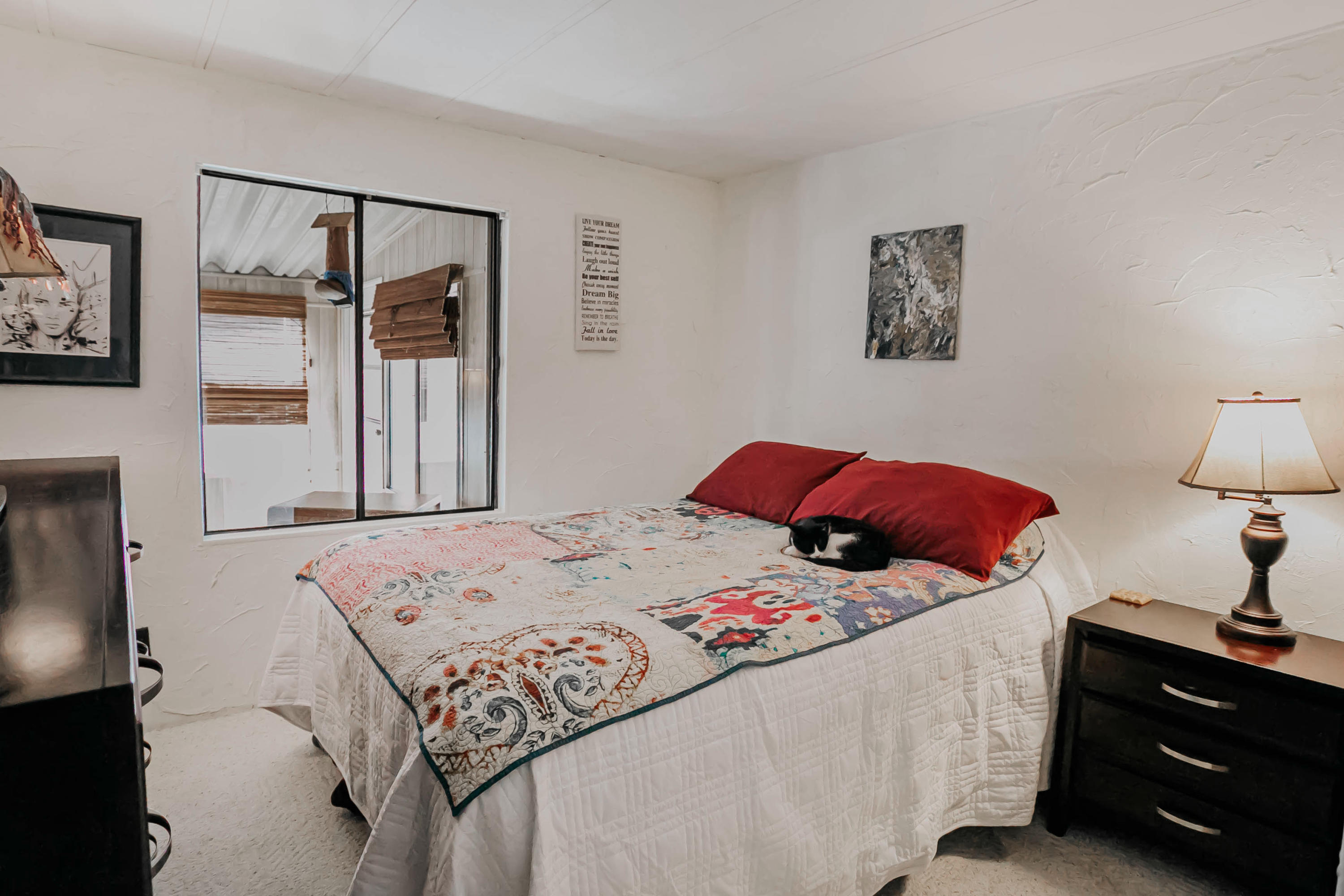 51555 Monroe Street, Unit 26 Indio, CA 92201 - Photo 30 of 54 a bedroom with a bed and a lamp on dresser