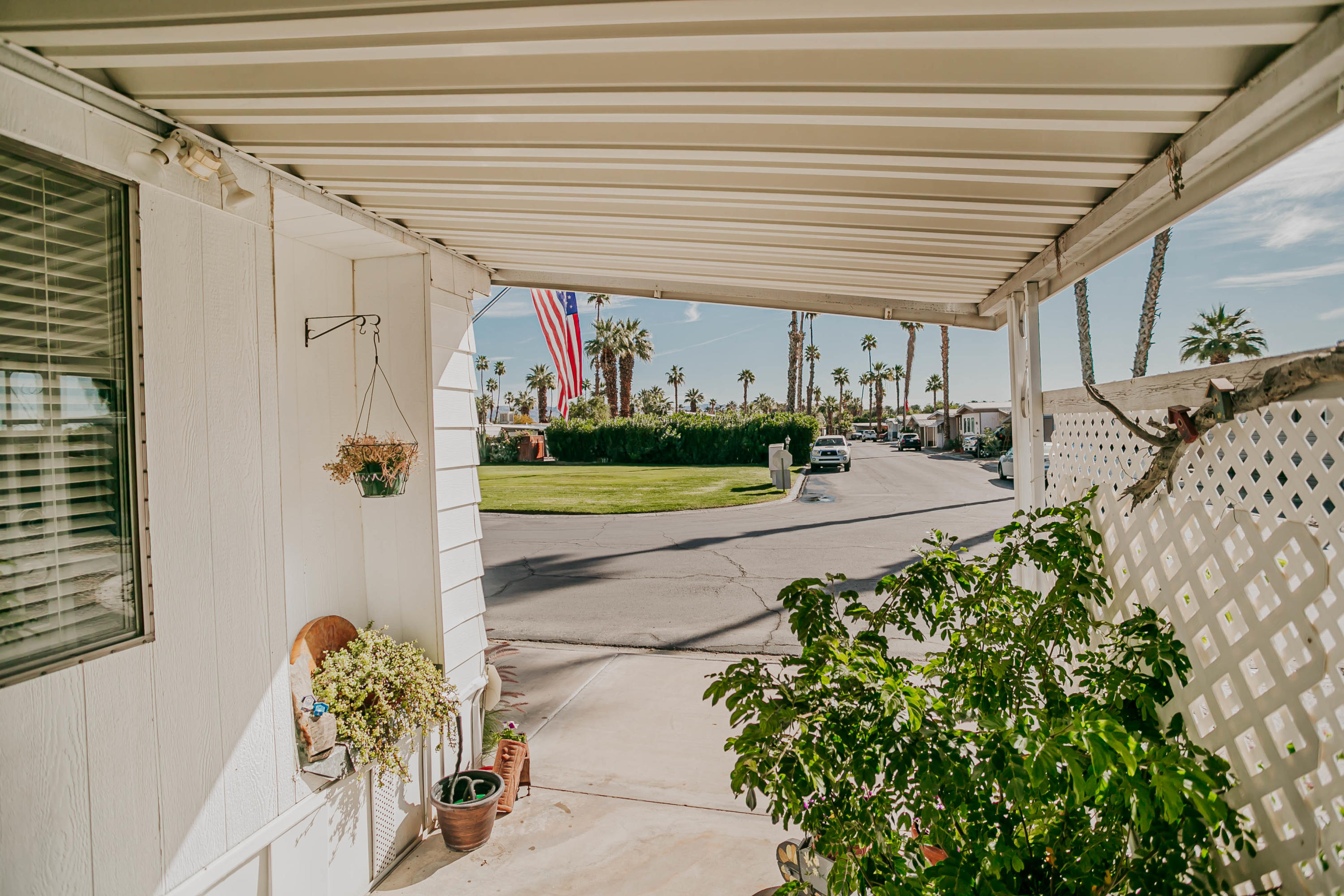 51555 Monroe Street, Unit 26 Indio, CA 92201 - Photo 4 of 54 a view of a porch with chairs and potted plants