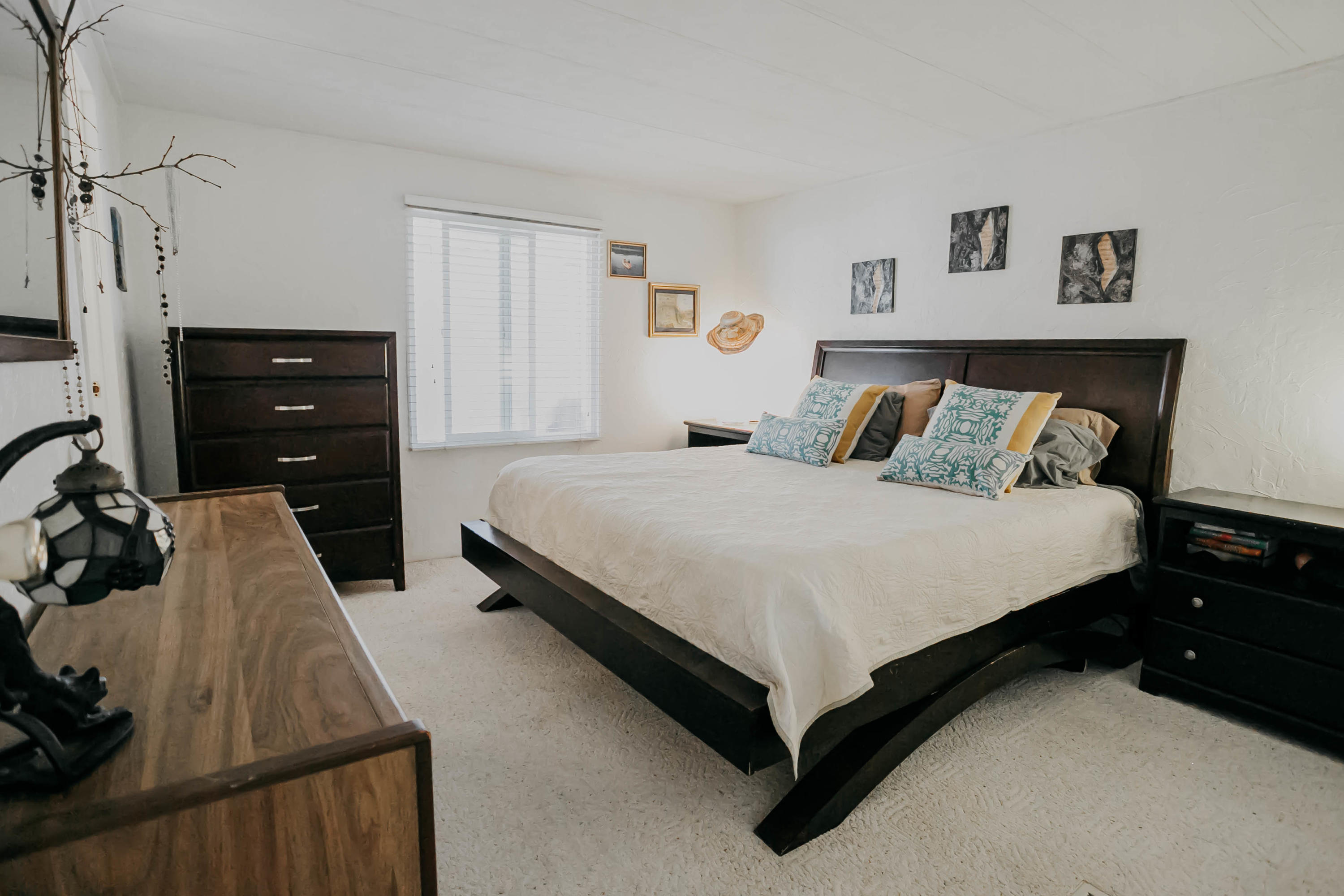 51555 Monroe Street, Unit 26 Indio, CA 92201 - Photo 33 of 54 a bedroom with a bed and a flat tv screen on dresser