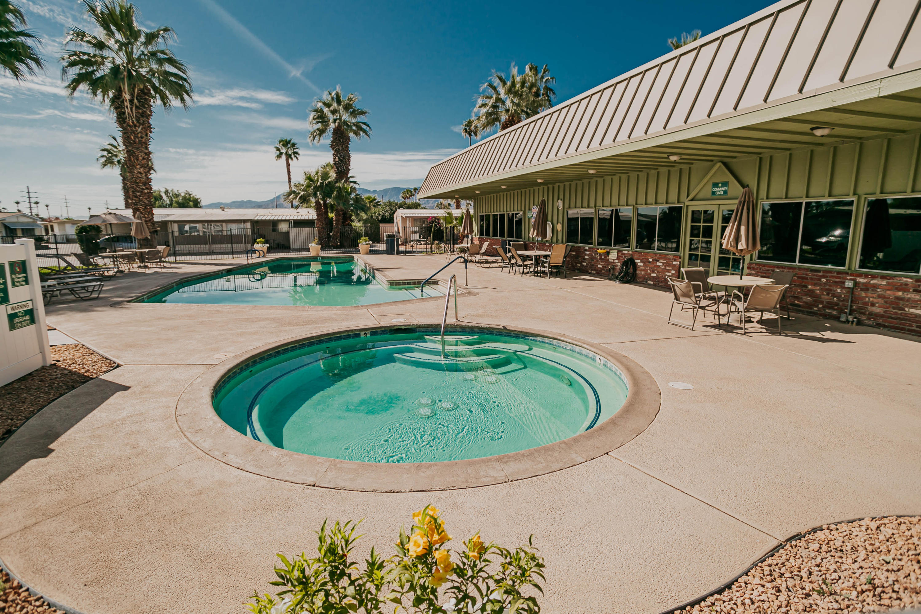 51555 Monroe Street, Unit 26 Indio, CA 92201 - Photo 48 of 54 an outdoor space with swimming pool and furniture