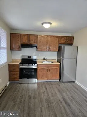 a kitchen with a refrigerator and a stove