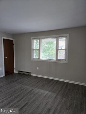 2204 Kirkwood Highway, Unit C Wilmington, DE 19805 - Photo 3 of 7 an empty room with wooden floor and windows