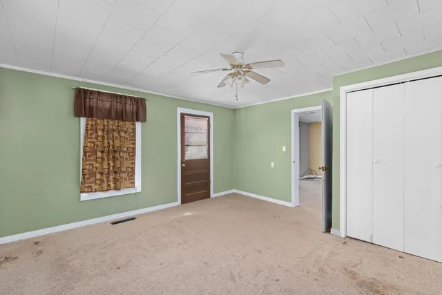 a view of an empty room with a ceiling fan