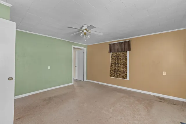 a view of an empty room with closet area