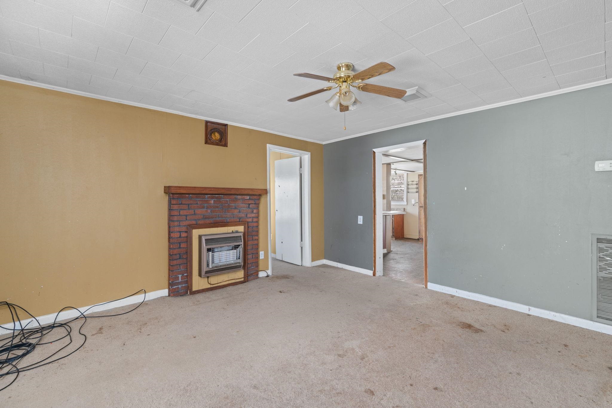 10 County Road 440 Iuka, MS 38852 - Photo 23 of 40 a view of an empty room with a fireplace and a window