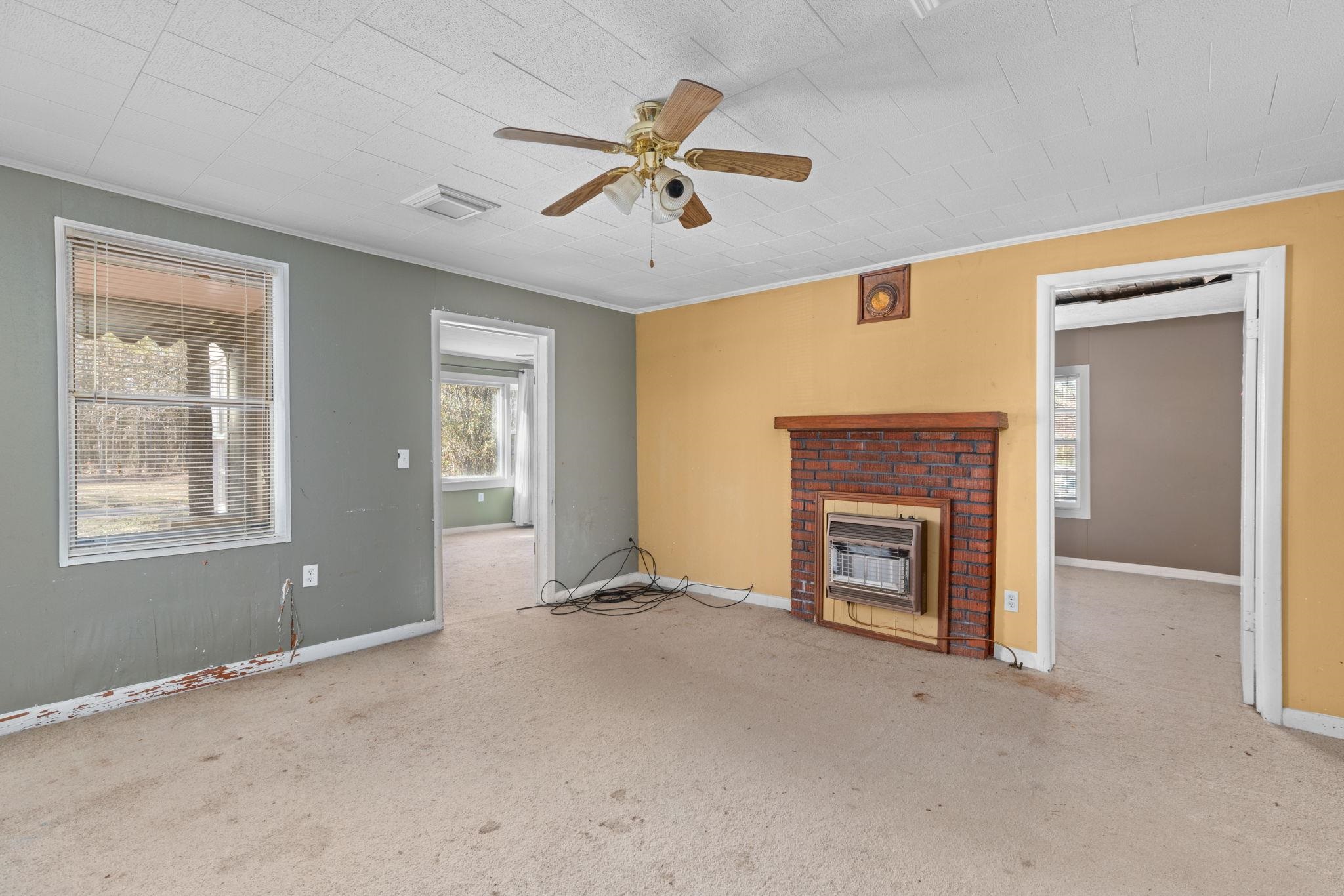 10 County Road 440 Iuka, MS 38852 - Photo 24 of 40 a view of a livingroom with a fireplace and windows