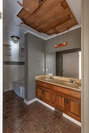 a bathroom with a toilet sink and mirror