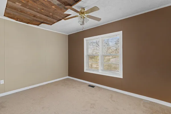 a view of a hallway with wooden floor and closet