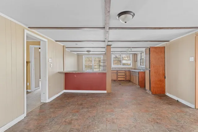 an empty room with closet and windows