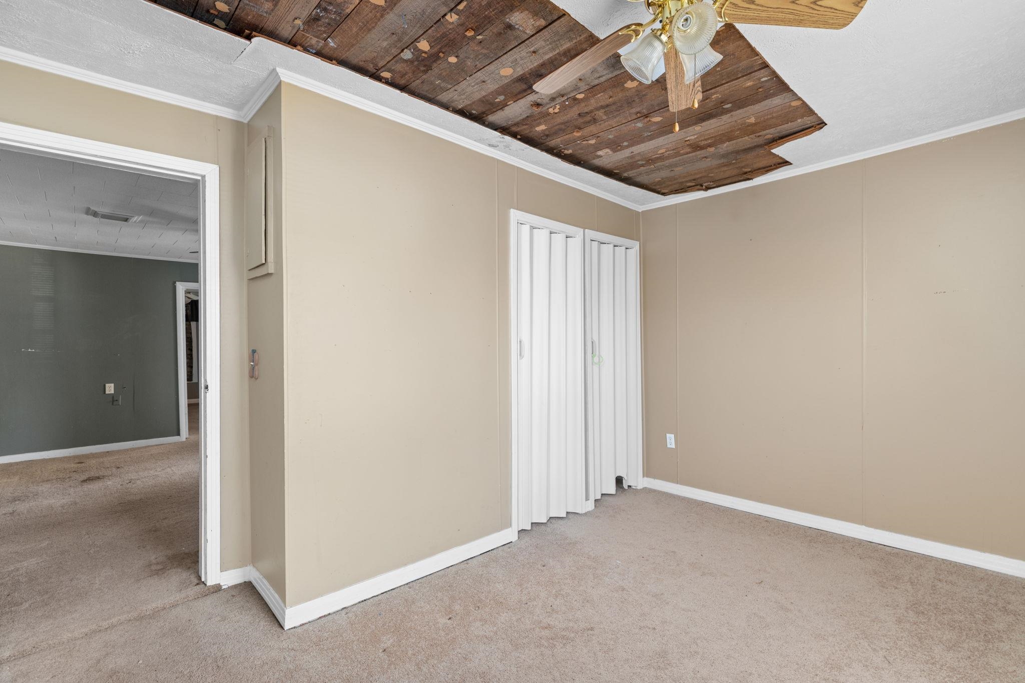 10 County Road 440 Iuka, MS 38852 - Photo 8 of 40 Unfurnished bedroom with crown molding, carpet flooring, ceiling fan, and wooden ceiling