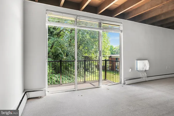 a view of an empty room with windows