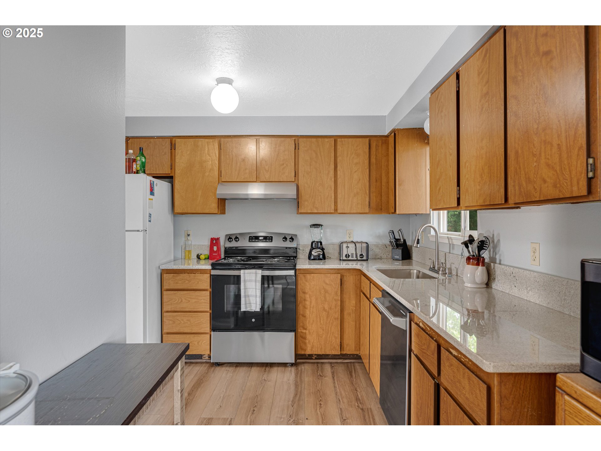 4591 Juliana Loop Southeast Salem, OR 97317 - Photo 13 of 32 a kitchen with stainless steel appliances granite countertop a sink a stove and a refrigerator