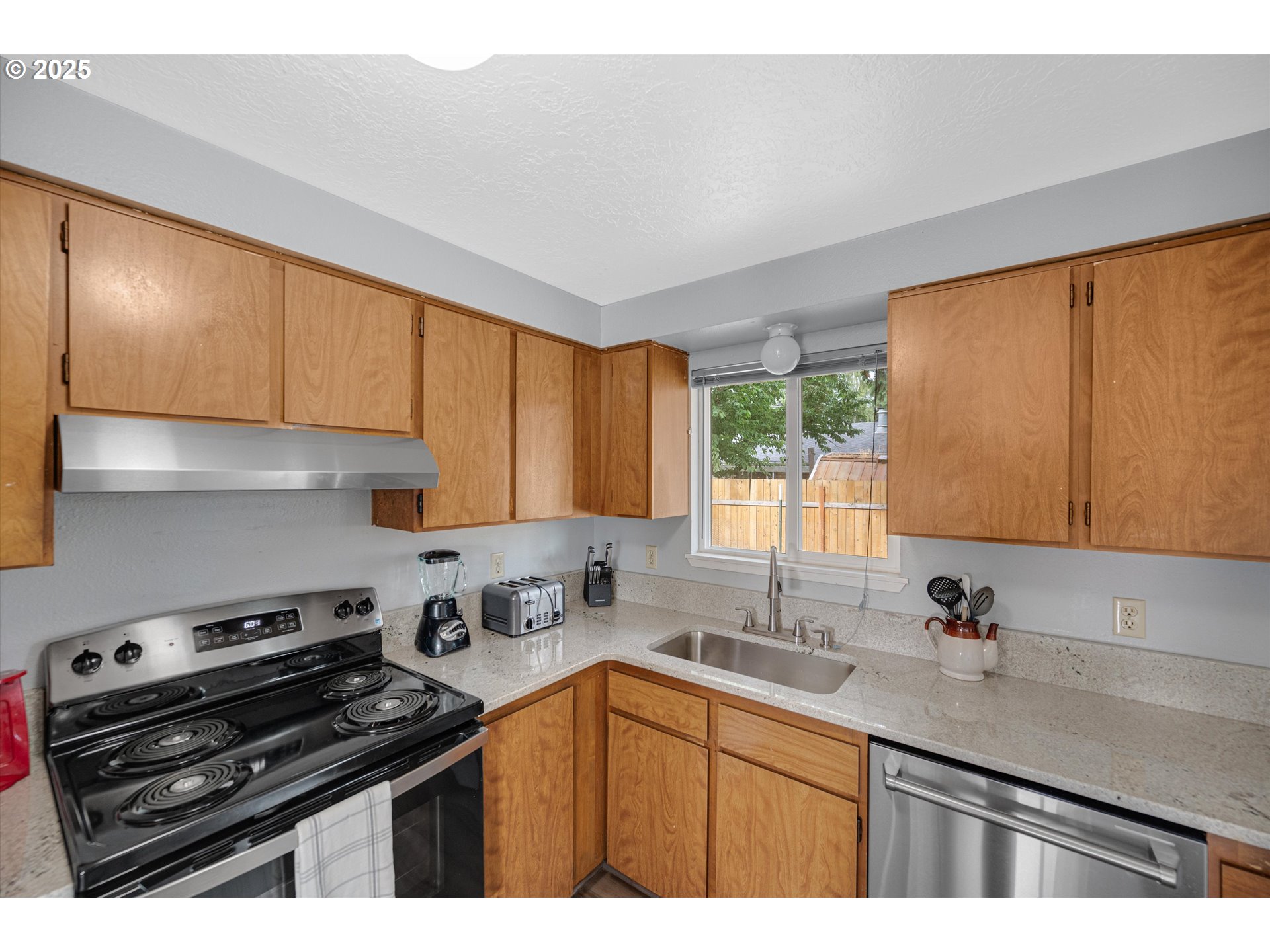 4591 Juliana Loop Southeast Salem, OR 97317 - Photo 15 of 32 a kitchen with a sink a stove cabinets and a window