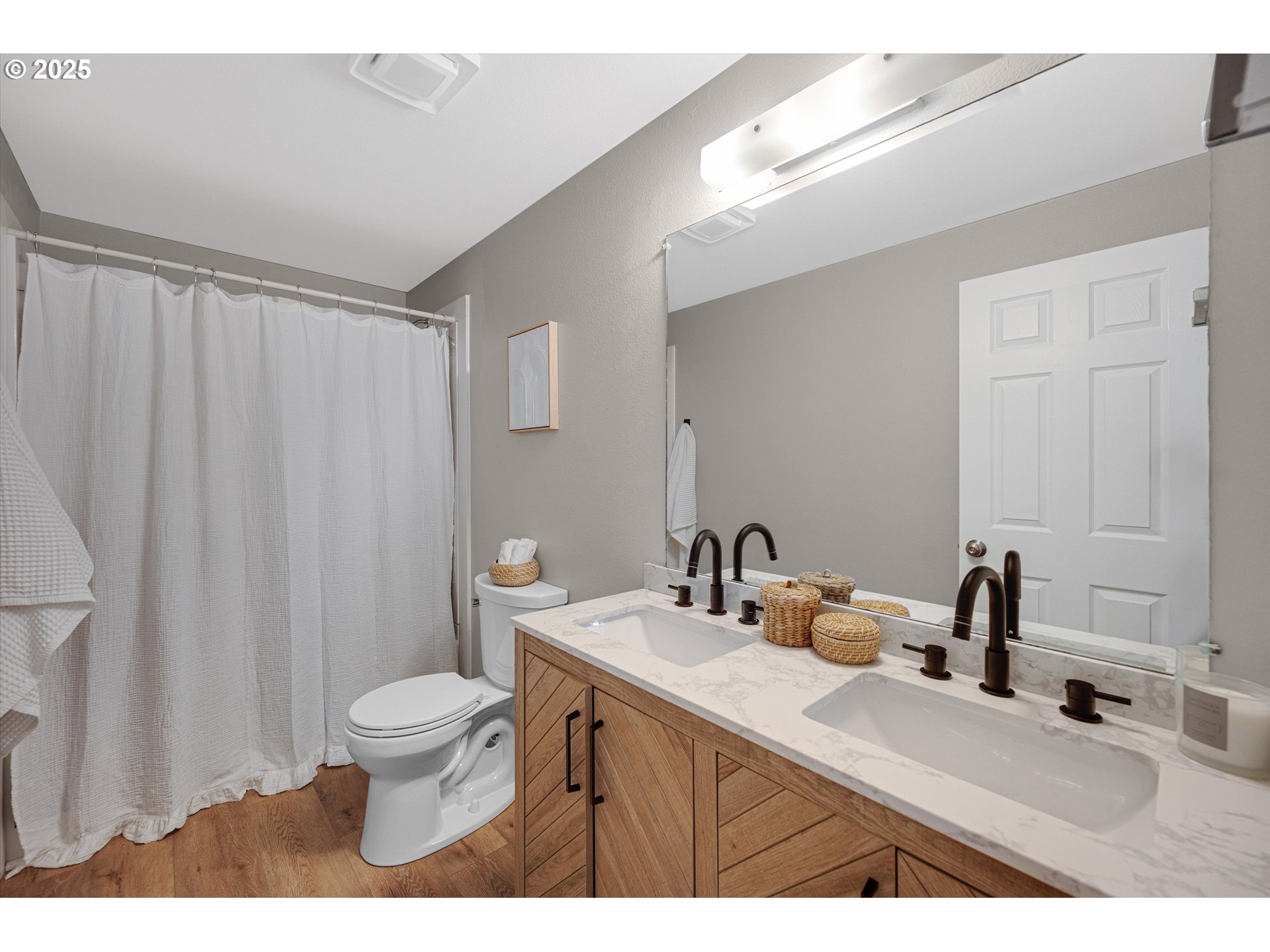 4591 Juliana Loop Southeast Salem, OR 97317 - Photo 19 of 32 a bathroom with a sink a toilet a mirror and shower curtain