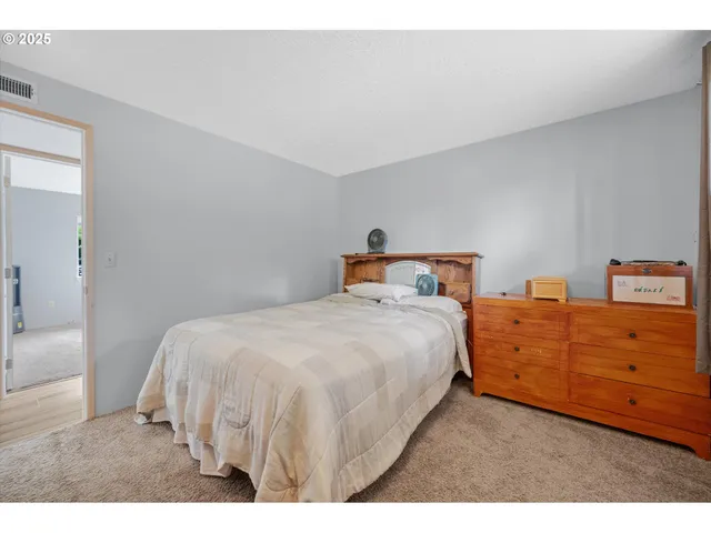 a bedroom with a bed and a table