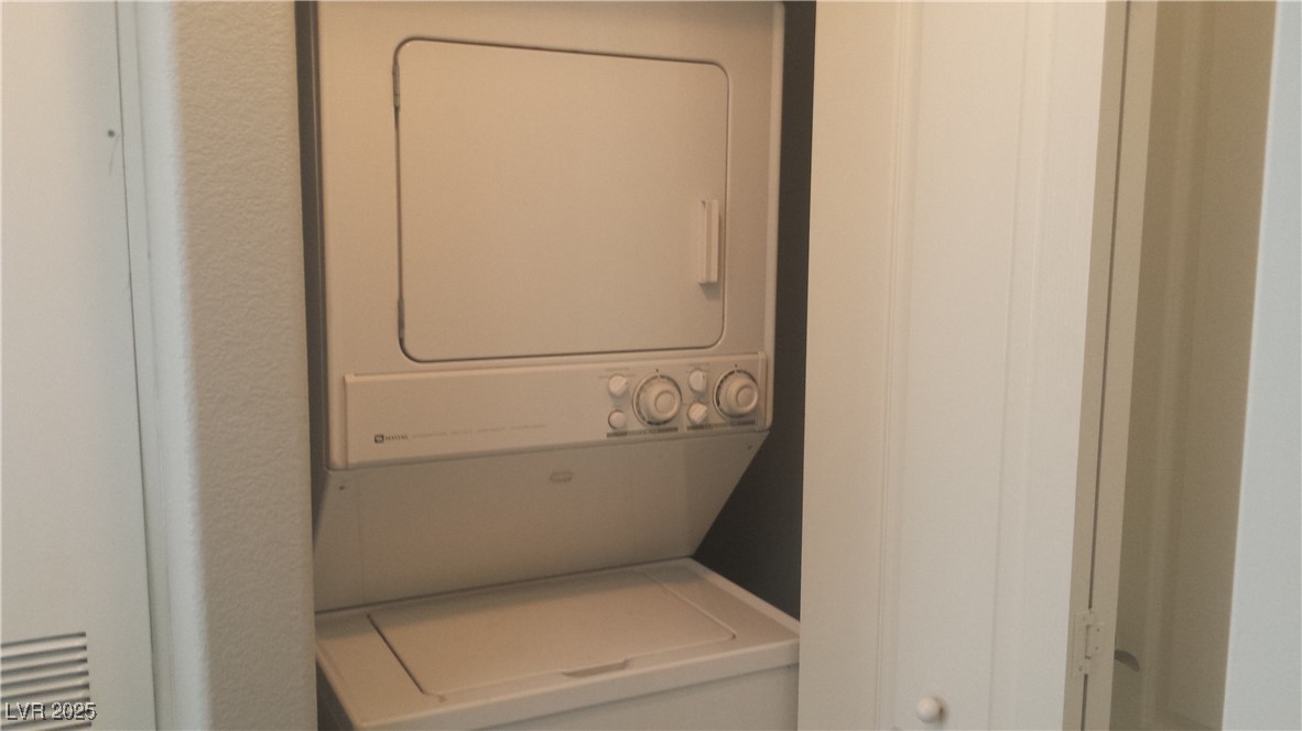 3411 Cactus Mountain Street, Unit 103 Las Vegas, NV 89129 - Photo 11 of 20 Laundry area featuring stacked washing machine and dryer