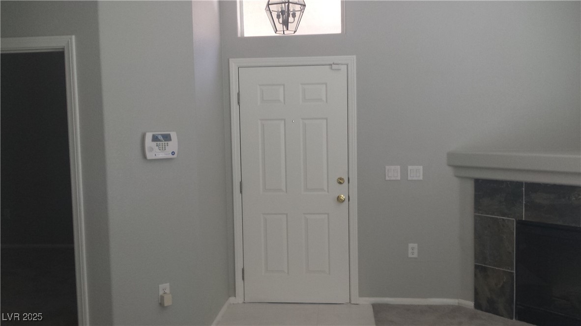 3411 Cactus Mountain Street, Unit 103 Las Vegas, NV 89129 - Photo 12 of 20 Entryway with baseboards and a fireplace