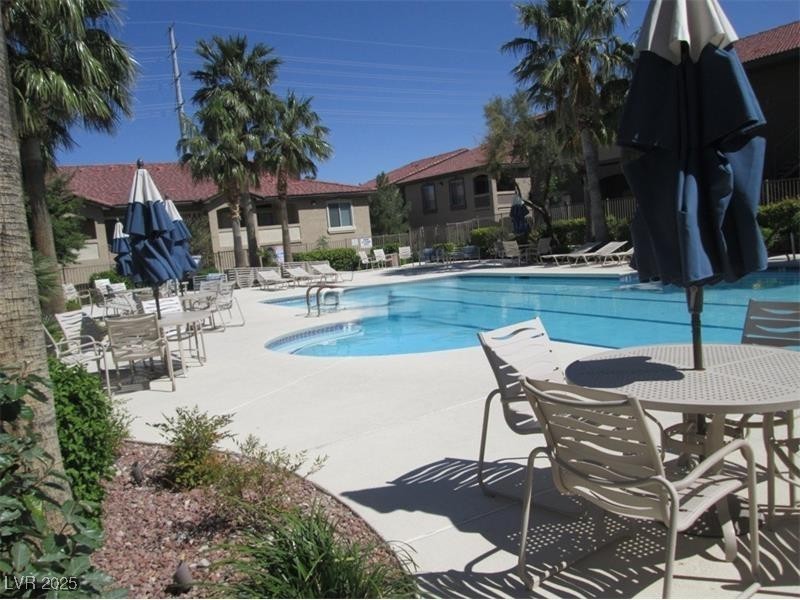 3411 Cactus Mountain Street, Unit 103 Las Vegas, NV 89129 - Photo 18 of 20 Community pool featuring a patio area and outdoor dining space