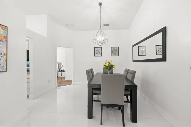a view of a dining room with furniture and chandelier