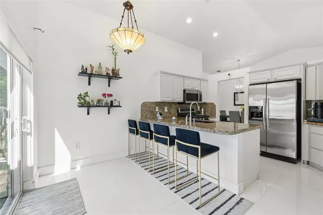 a kitchen with refrigerator and cabinets