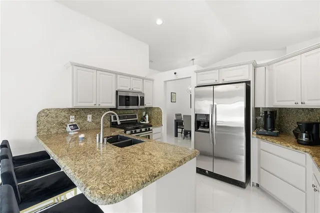 a kitchen with a refrigerator stove and microwave