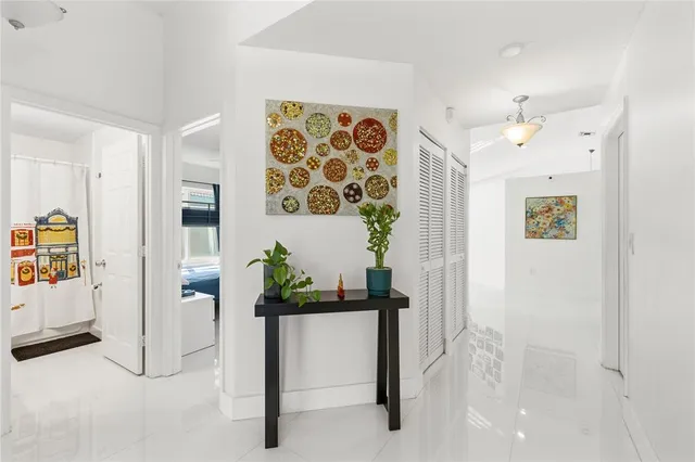 a view of a hallway with paintings on the wall