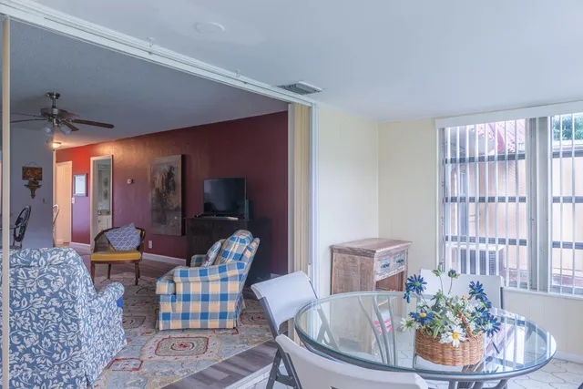 a dining room with furniture and wooden floor